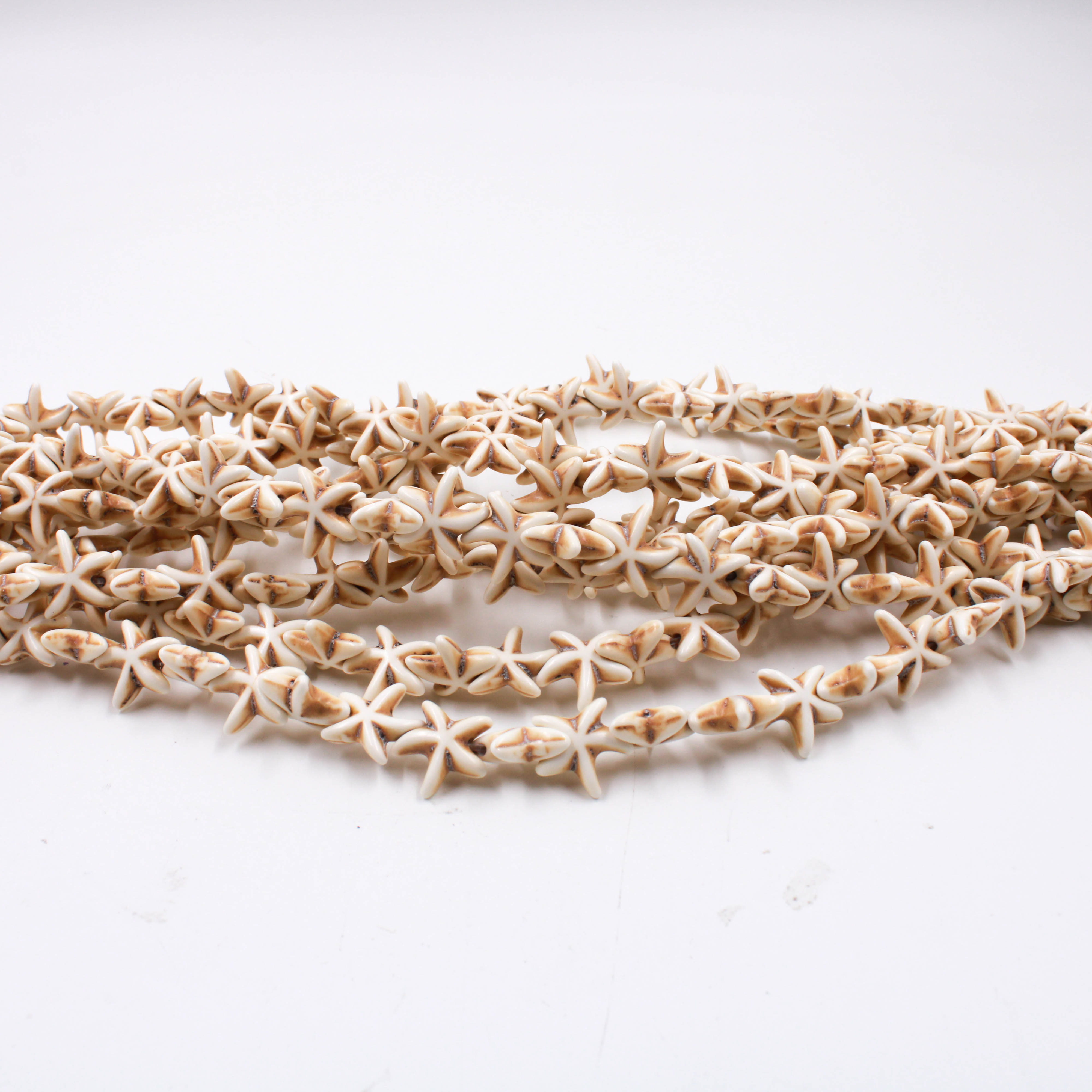 ESTRELA-PASSANTE-14MM-EM-HOWLITA-NATURAL-COM-10-FIOS---209---BRANCO-209